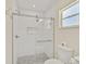 Modern shower with white-tiled walls, a glass door, and chrome fixtures offering an elegant and bright space at 8007 17Th Nw Ave, Bradenton, FL 34209