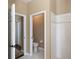 Bright bathroom with a toilet room, and a tiled shower with grab bars at 8078 Stirling Falls Cir, Sarasota, FL 34243