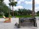 Relaxing beach with colorful Adirondack chairs near the water, and a decorative wooden headboard on the sand at 8078 Stirling Falls Cir, Sarasota, FL 34243