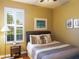 Cozy bedroom features a comfortable bed with decorative pillows and natural light from the window at 8078 Stirling Falls Cir, Sarasota, FL 34243