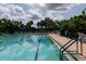 Relaxing community pool surrounded by comfortable lounge chairs and lush landscaping at 8078 Stirling Falls Cir, Sarasota, FL 34243