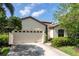 Charming home with a two-car garage, tile roof, and lovely landscaping at 8078 Stirling Falls Cir, Sarasota, FL 34243