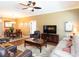 Comfortable living room with a ceiling fan, TV, and adjacent dining area at 8078 Stirling Falls Cir, Sarasota, FL 34243