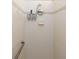 Clean and functional shower with tiled walls, grab bar, and built-in soap and shampoo dispensers at 8078 Stirling Falls Cir, Sarasota, FL 34243