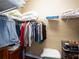 Well-organized walk-in closet with shelves and rods for clothing and accessories at 8078 Stirling Falls Cir, Sarasota, FL 34243
