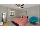 Comfortable bedroom with a ceiling fan, neutral paint, and a large window providing natural light at 8472 60Th N St # 702, Pinellas Park, FL 33781
