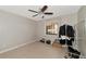 A simple bedroom with a ceiling fan, tiled floor and natural light through the window at 8472 60Th N St # 702, Pinellas Park, FL 33781