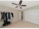 Another bedroom view showing ample closet space, tiled flooring, and a ceiling fan, great for comfort at 8472 60Th N St # 702, Pinellas Park, FL 33781