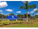 Exterior view of the community City Courts featuring lush greenery and palm trees against a blue sky at 8472 60Th N St # 702, Pinellas Park, FL 33781