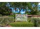 The Villas of Pinellas Farms signage, surrounded by lush landscaping, inviting you to your new home at 8472 60Th N St # 702, Pinellas Park, FL 33781