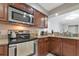 Well-equipped kitchen featuring granite countertops, stainless steel appliances, and warm wood cabinetry at 8472 60Th N St # 702, Pinellas Park, FL 33781