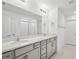 Bathroom featuring double vanity, white countertops, and a glass shower at 8815 Windlass Cv, Parrish, FL 34219