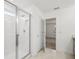 Bathroom with white subway tile shower and glass door and an adjoining bedroom at 8815 Windlass Cv, Parrish, FL 34219