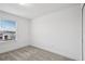 An empty, carpeted bedroom with a window view at 8815 Windlass Cv, Parrish, FL 34219