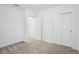 A simple, carpeted bedroom with closet and door at 8815 Windlass Cv, Parrish, FL 34219