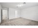 Large carpeted bedroom with white walls and multiple doorways at 8815 Windlass Cv, Parrish, FL 34219