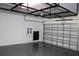 Spacious garage features overhead storage racks and ample room for vehicles and projects at 8815 Windlass Cv, Parrish, FL 34219