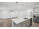 Open concept kitchen with a large island, pendant lighting, and stainless steel appliances at 8815 Windlass Cv, Parrish, FL 34219