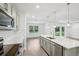 Kitchen with large island opening to the living room and backyard at 8815 Windlass Cv, Parrish, FL 34219