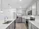 Modern kitchen with stainless steel appliances, gray cabinets and a large island at 8815 Windlass Cv, Parrish, FL 34219