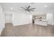 Bright living room with wood-look floors, open concept to the kitchen, and recessed lighting at 8815 Windlass Cv, Parrish, FL 34219
