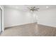Spacious living room with wood-look floors, recessed lighting, and ceiling fan at 8815 Windlass Cv, Parrish, FL 34219