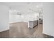 Expansive living space featuring wood-look floors, recessed lights, and an open floor plan at 8815 Windlass Cv, Parrish, FL 34219