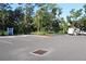 Spacious parking lot surrounded by beautiful trees, offering ample parking spaces and a peaceful natural setting at 8815 Windlass Cv, Parrish, FL 34219