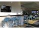 Beautifully designed clubhouse bar with modern furniture, large-screen TV, and stylish finishes near the pool at 8815 Windlass Cv, Parrish, FL 34219