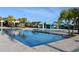 Gorgeous community pool surrounded by lush landscaping, cabanas, and comfortable seating for relaxation at 8815 Windlass Cv, Parrish, FL 34219