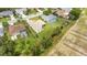 Aerial view displays a home with fenced yard, pond, lanai, and well-kept landscaping at 9402 71St E Ave, Palmetto, FL 34221