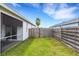 Private, grassy backyard area with a screened-in lanai, offering a tranquil outdoor retreat at 9402 71St E Ave, Palmetto, FL 34221
