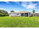 Expansive backyard featuring a well-manicured lawn, a wooden deck, and screened-in lanai at 9402 71St E Ave, Palmetto, FL 34221