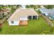 Aerial view of a home showcasing a spacious backyard with a screened porch and wooden deck at 9402 71St E Ave, Palmetto, FL 34221