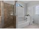 Bathroom featuring a shower, tub, and window with privacy blinds at 9402 71St E Ave, Palmetto, FL 34221