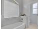 Modern bathroom featuring a white tub with marble-style tile surround at 9402 71St E Ave, Palmetto, FL 34221