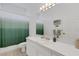 Simple bathroom with a large mirror, neutral tiled floor, and shower curtain at 9402 71St E Ave, Palmetto, FL 34221