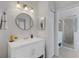 Bathroom featuring a round mirror above a vanity and a glass-enclosed shower at 9402 71St E Ave, Palmetto, FL 34221