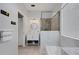 A tiled bathroom features a white vanity, shower, and tub combination at 9402 71St E Ave, Palmetto, FL 34221