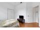 Bedroom with hardwood floors, a bed with a decorative quilt, a television, and a ceiling fan at 9402 71St E Ave, Palmetto, FL 34221