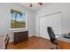 Bedroom showcasing hardwood floors, a ceiling fan, a window with blinds, and a built-in cabinet at 9402 71St E Ave, Palmetto, FL 34221