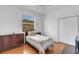 Bedroom featuring a bed with decorative quilt, wood floors, ceiling fan, and dresser at 9402 71St E Ave, Palmetto, FL 34221