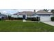 Charming single-story home with blue and white trim, well-manicured lawn, and a two-car garage at 9402 71St E Ave, Palmetto, FL 34221