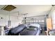Attached garage with a ceiling fan, two parked cars under covers, and an automatic garage door at 9402 71St E Ave, Palmetto, FL 34221