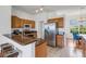 Well-lit kitchen features modern appliances, a breakfast bar, and wood cabinets perfect for any home chef at 9402 71St E Ave, Palmetto, FL 34221