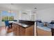 Open kitchen and dining area featuring wooden cabinetry and a breakfast bar, ideal for entertaining at 9402 71St E Ave, Palmetto, FL 34221