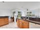 Open-concept kitchen with breakfast bar and backyard views, offering a seamless indoor-outdoor living experience at 9402 71St E Ave, Palmetto, FL 34221