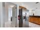 Kitchen with stainless steel refrigerator next to laundry room, combining functionality with modern design at 9402 71St E Ave, Palmetto, FL 34221