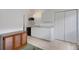 Bright laundry room featuring a mini fridge, utility sink, white cabinets, and closet for added storage at 9402 71St E Ave, Palmetto, FL 34221