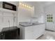 Laundry room featuring modern appliances, white cabinets, a utility sink, and natural light from a window at 9402 71St E Ave, Palmetto, FL 34221